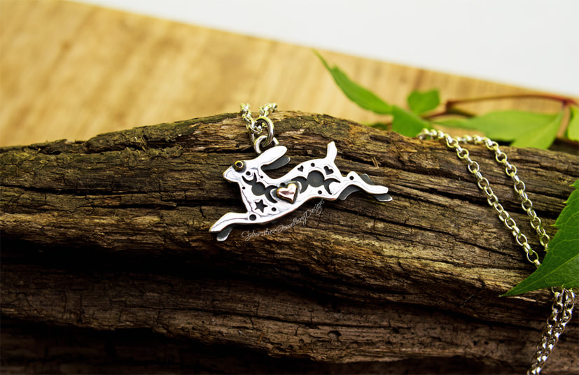 Small silver hare pendant with gold and diamond