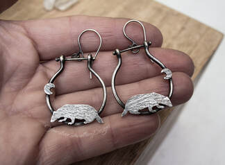 Silver hoop earrings with badgers