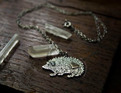 silver and gold hedgehog necklace