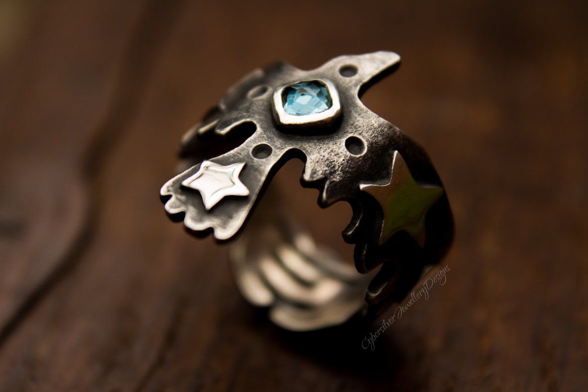 Raven ring with blue topaz