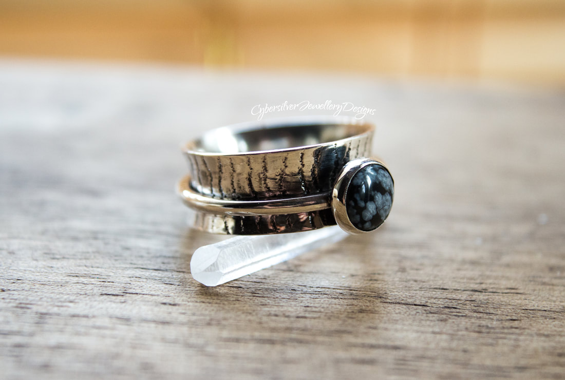 Silver spinner ring with snowflake obsidian