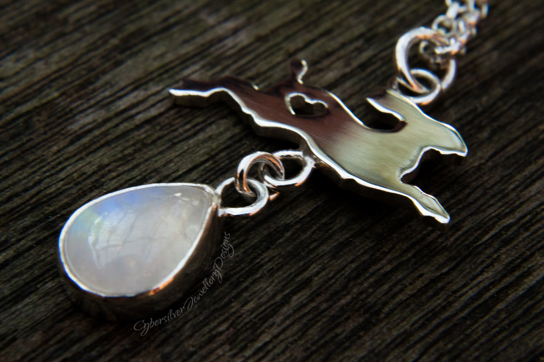 Tiny silver hare with blue moonstone